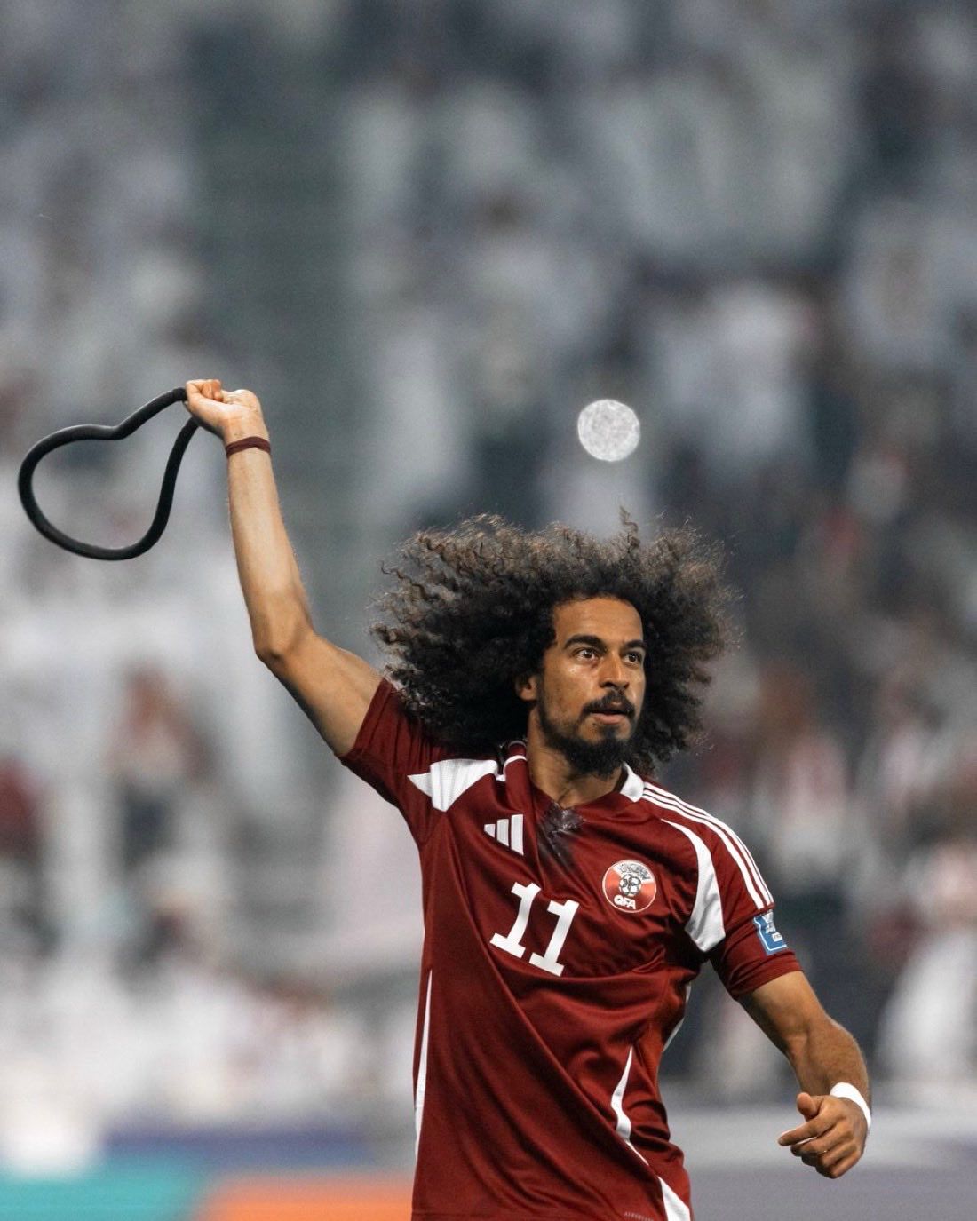 A fan gives Akram Afif a camel to celebrate the World Cup